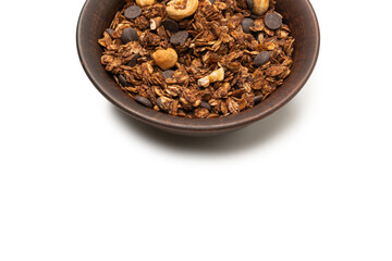 Chocolate granola cereal with nuts in a bowl background.