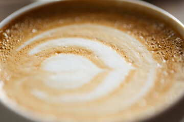 Thick milk foam in a cup of cappuccino, macro shot