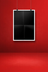 Black folded poster hanging on a red wall with clips