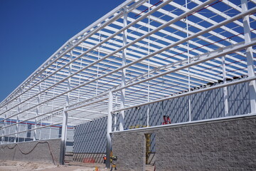 Metal wite frame of the new building against the sky © Mylifeontopdm