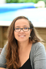 young woman with blue eyes and glasses