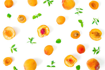 Fruit pattern of apricot and peaches with mint leaves on white background. Flat lay