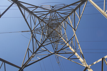 Power lines during a beautiful sunset. Electricity transportation on beautiful landscapes of the world.