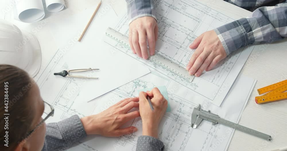 Poster architects are working on a building construction sketches design project. engineers draw blueprints
