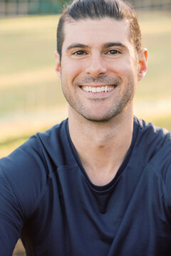 Close-up of a young sportsman at a soccer field wearing a blue shirt