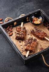 Chocolate ice cream popsicle with nut