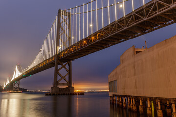 The Bay Bridge and Pier 24 via the Embarcadero, San Francisco, California, USA.