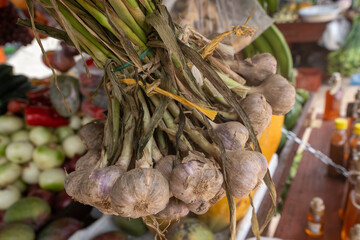 bunch of garlic hanging in the marketplace.