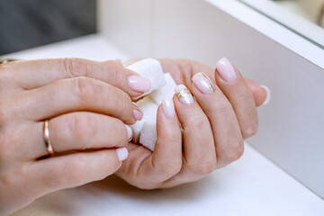 White sugar cubes lie in the palm of your hand. Beautiful nude manicure with decor.