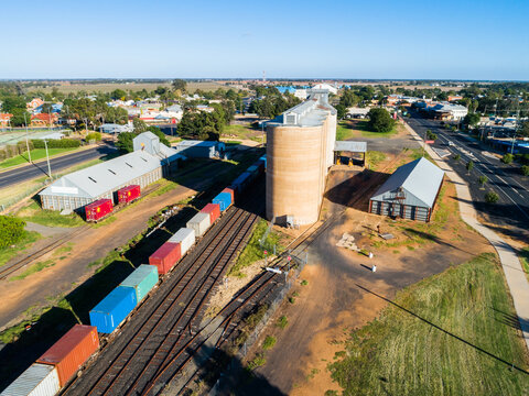 Aussie country town scene in Narromine of grain silos beside railway and freight train