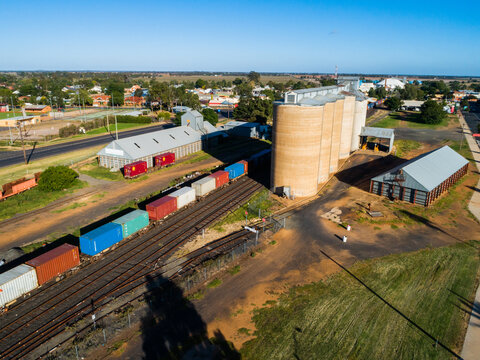 Aussie country town scene in Narromine of grain silos beside railway and freight train