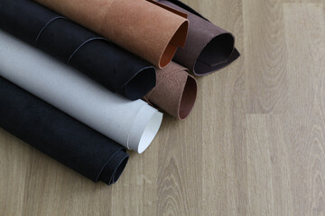 Pieces of the leather on the working desk in the leather workshop. View from above. Space for text