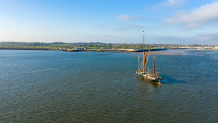 Beautiful aerial view on vintage caravel on sunlit sea water. Scenic travel concept, Brightlingsea, Essex, UK