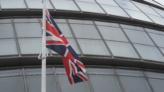Slow Motion. A British flag in front of an office building.