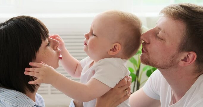 Parents having fun with baby son at home