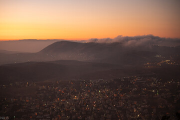 Sunrise over a city in the fog