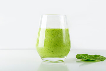 Green smoothie from spinach, apple, cucumber and soy milk in glass on white background. Home cooking. Vegan healthy detox eating, dietary and weght loss drink