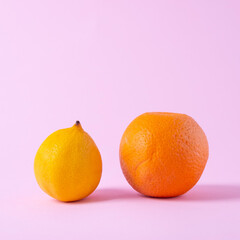 close-up orange and lemon minimalism on a pink background