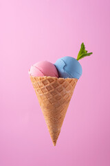 ice cream in waffle cone on pink background minimalistic concept