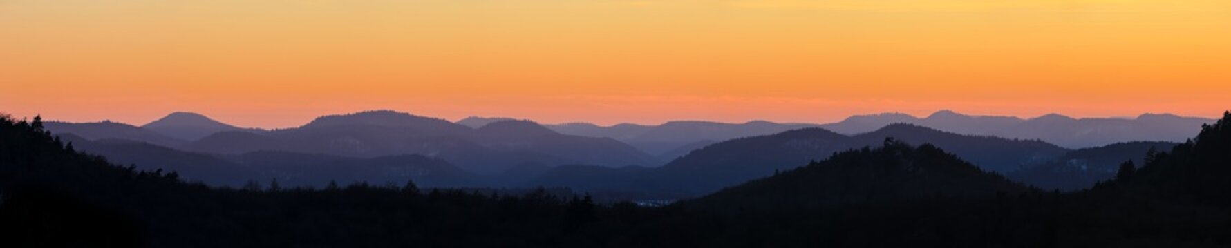 mountain layers after sunset during golden hour, orange sky, mountain silhouettes, sky during dusk