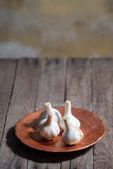 young garlic on a wooden background in a rustic style. minimalistic