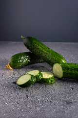 cucumber water drops on a white-gray background. minimalistic still life of fresh cucumber