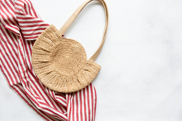 Summer womens bag and beach towel on white background, flat style, top view