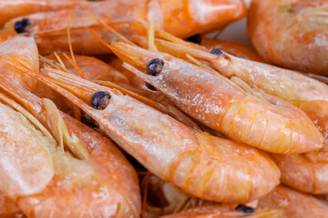 Close-up boiled unpeeled shrimp and prawns. Seafood of the order of crustaceans