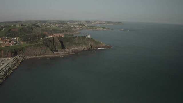 Aerial video view of the port, the lighthouse and the town of Candás, Asturias. Spain.