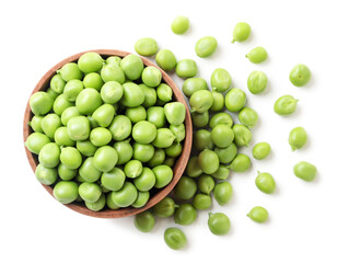 Green peas in a wooden plate and sprinkled on a white background. Top view.