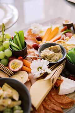 Close up photo of grapes, dragon fruit, cucumber, cheese, ham, fruits and vegetables