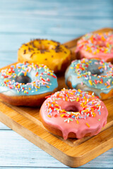 Delicious assorted colorful donuts on the table.