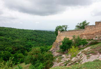 Fototapeta premium A stone fence over a cliff. The old wall of the medieval city.