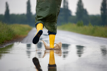 Farmer in rain clothes and shoes running outdoor