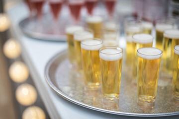 Champagne and wine in small flutes on serving tray