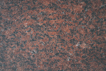 Natural pattern of polished red granite. The texture and background of the stone. Vanga granite...