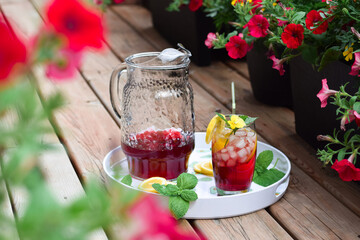 Colorful red cold summer drink on a balcony or patio