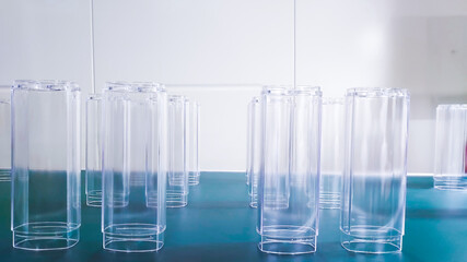 Glass plastic cosmetic bottles, in the production line, from the injection molding machine at the product manufacturing department in the factory.