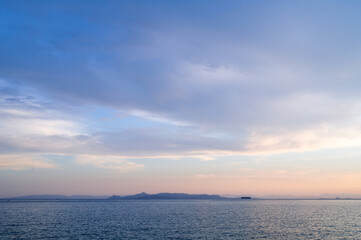 Beautiful landscape of sunset over Aegean sea in Athens, Greece. Calm water. Silhouettes of islands.