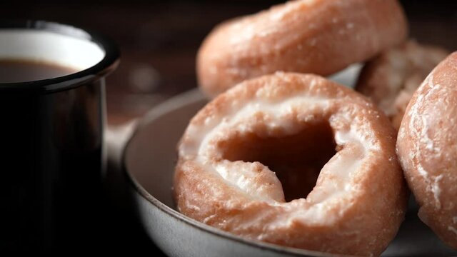 glazed old fashioned style doughnut on dark background