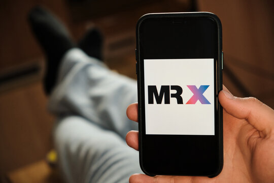 MR X logo of dating application on the screen of mobile phone in males hand, June 2021, San Francisco, USA