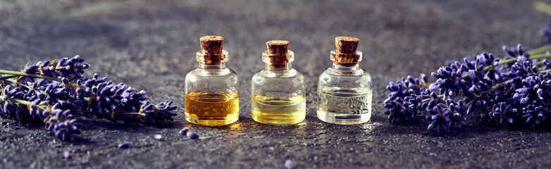 Panoramic banner of essential oil bottles with lavender flowers