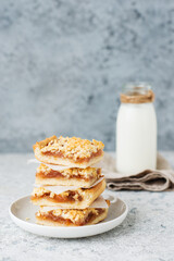 Homemade berry crumble bars with jam, homemade cookies with milk, selective focus