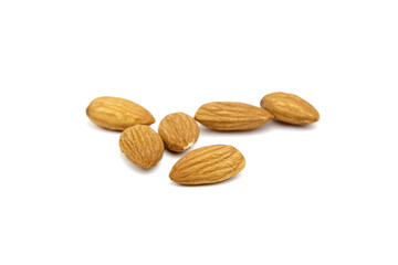 Almond nuts isolated on white background. Heap of scattered almonds