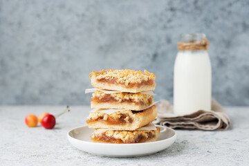 Homemade berry crumble bars with jam, homemade cookies with milk, copy space