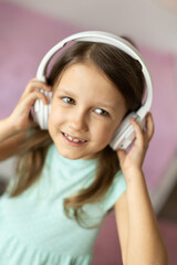 girl child listening to music with headphones