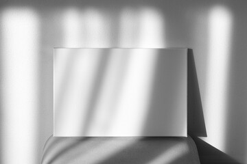 Blank picture mockup. White canvas mockup on shelf on wall with shadows. Stretched canvas