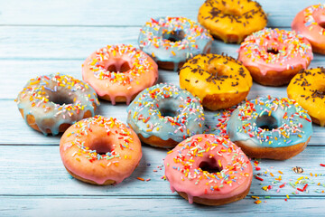 Delicious assorted colorful donuts on the table.