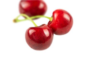 Three berries of a red sweet cherry close-up isolated on a white background.