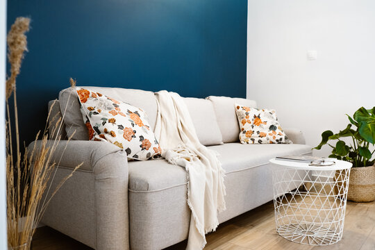 White sofa in a cosy room with pillows.